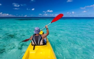 Photo of a Man Paddling in the Atlantic Using One of the Sturdiest Myrtle Beach Kayak Rentals.